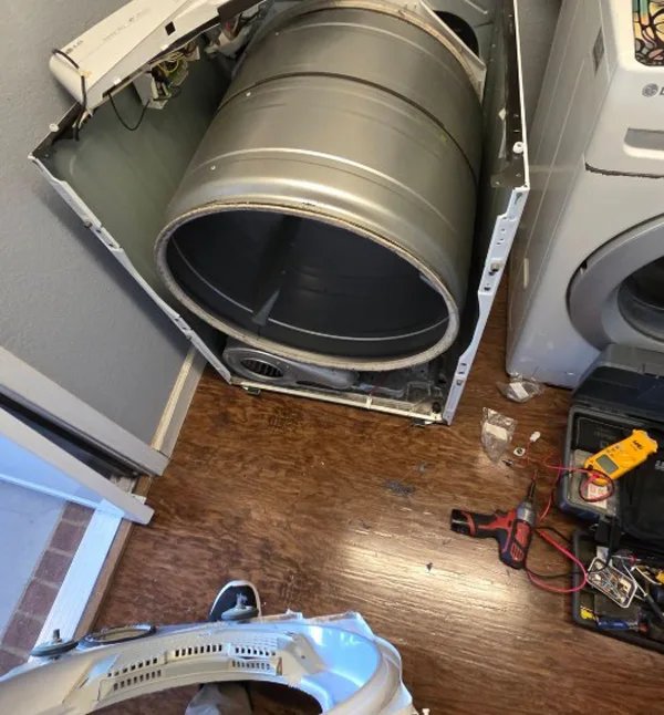 Technician diagnosing a washing machine in a Nairobi home